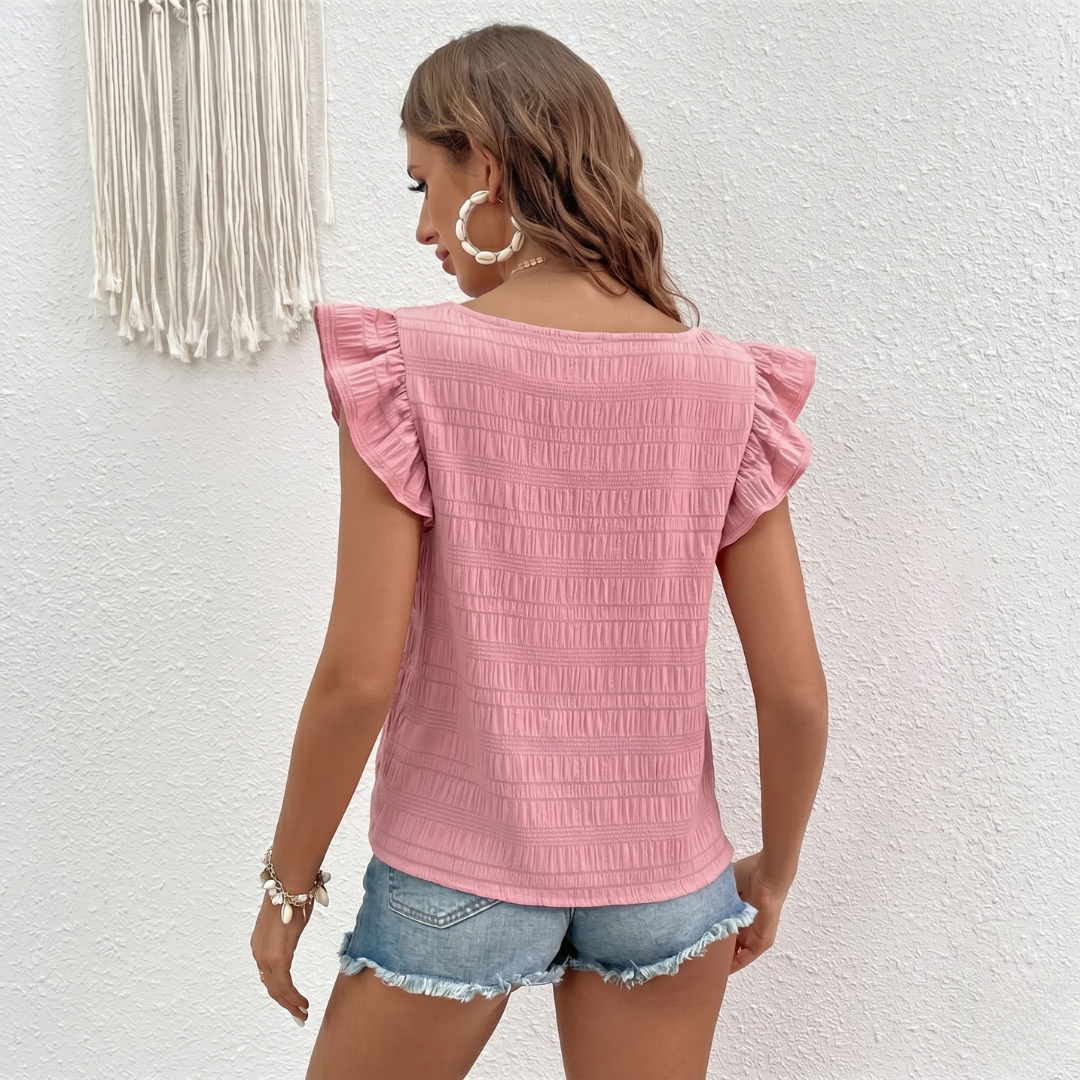 Retro della blusa rosa con orlo dritto e superficie leggermente increspata