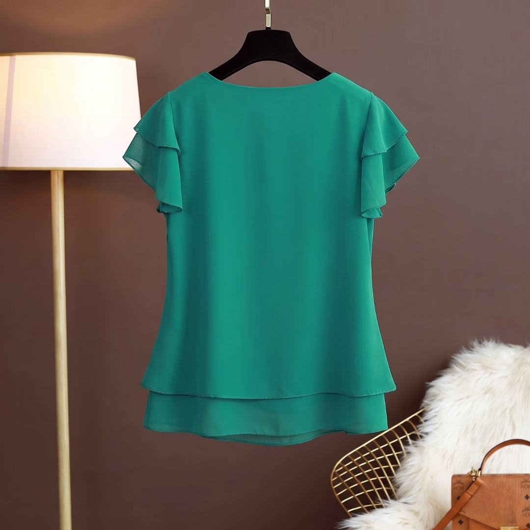 Retro della camicetta verde scuro con linea fluida e orlo sovrapposto