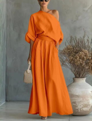 Completo donna arancione acceso con spalla scoperta e pantaloni ampi drappeggiati in vita