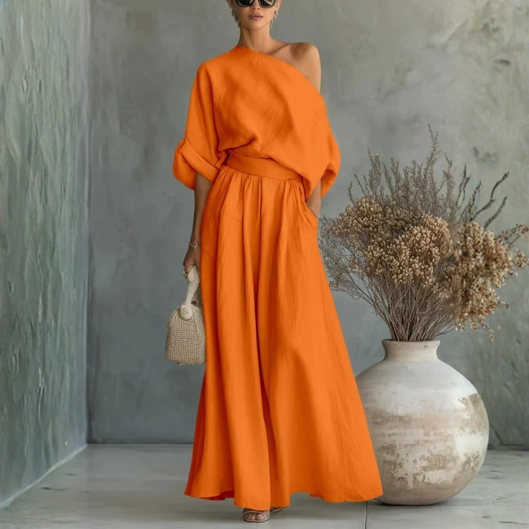 Completo donna arancione acceso con spalla scoperta e pantaloni ampi drappeggiati in vita