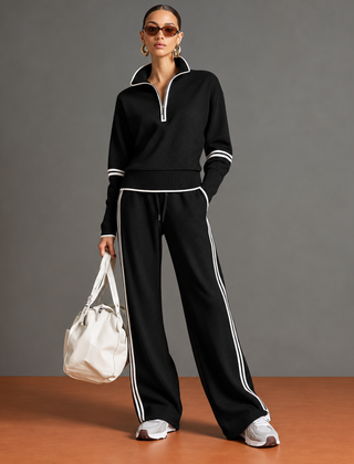 Completo donna nero con mezza zip e pantaloni larghi con righe bianche