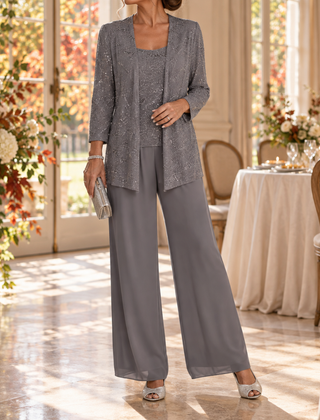Completo grigio scuro con giacca a paillettes e pantaloni fluidi