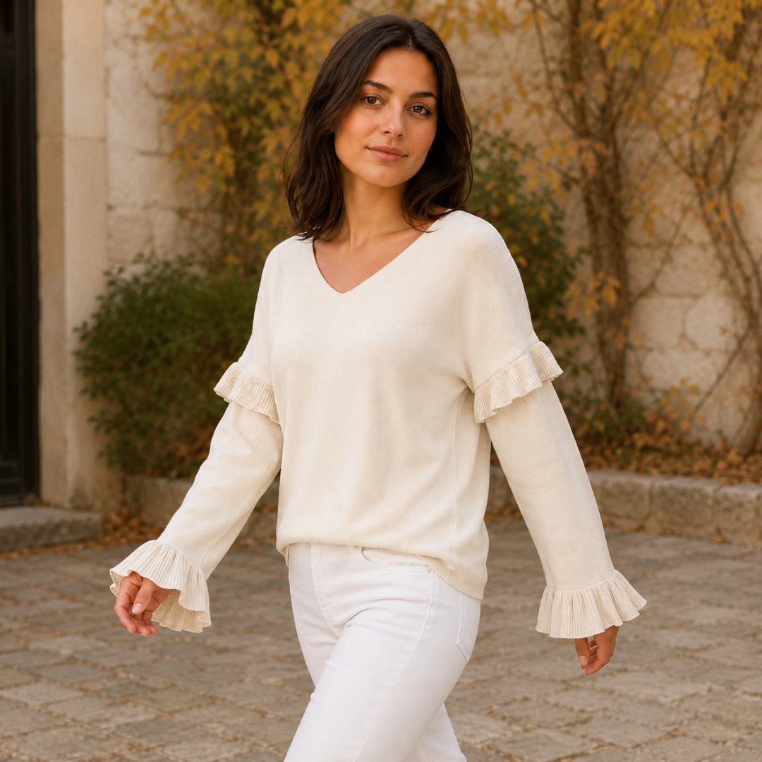 Donna in cammino con maglione albicocca a scollo a V e volant sulle maniche