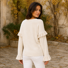 Retro del maglione albicocca con volant sulle spalle e polsini plissettati svasati