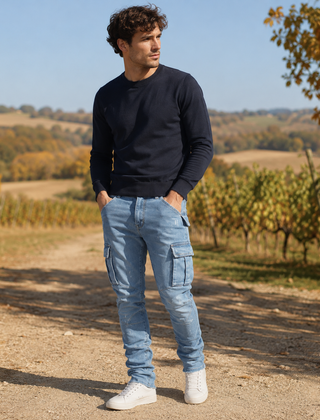 Uomo in pantaloni cargo azzurri con tasche a patta e maglione blu