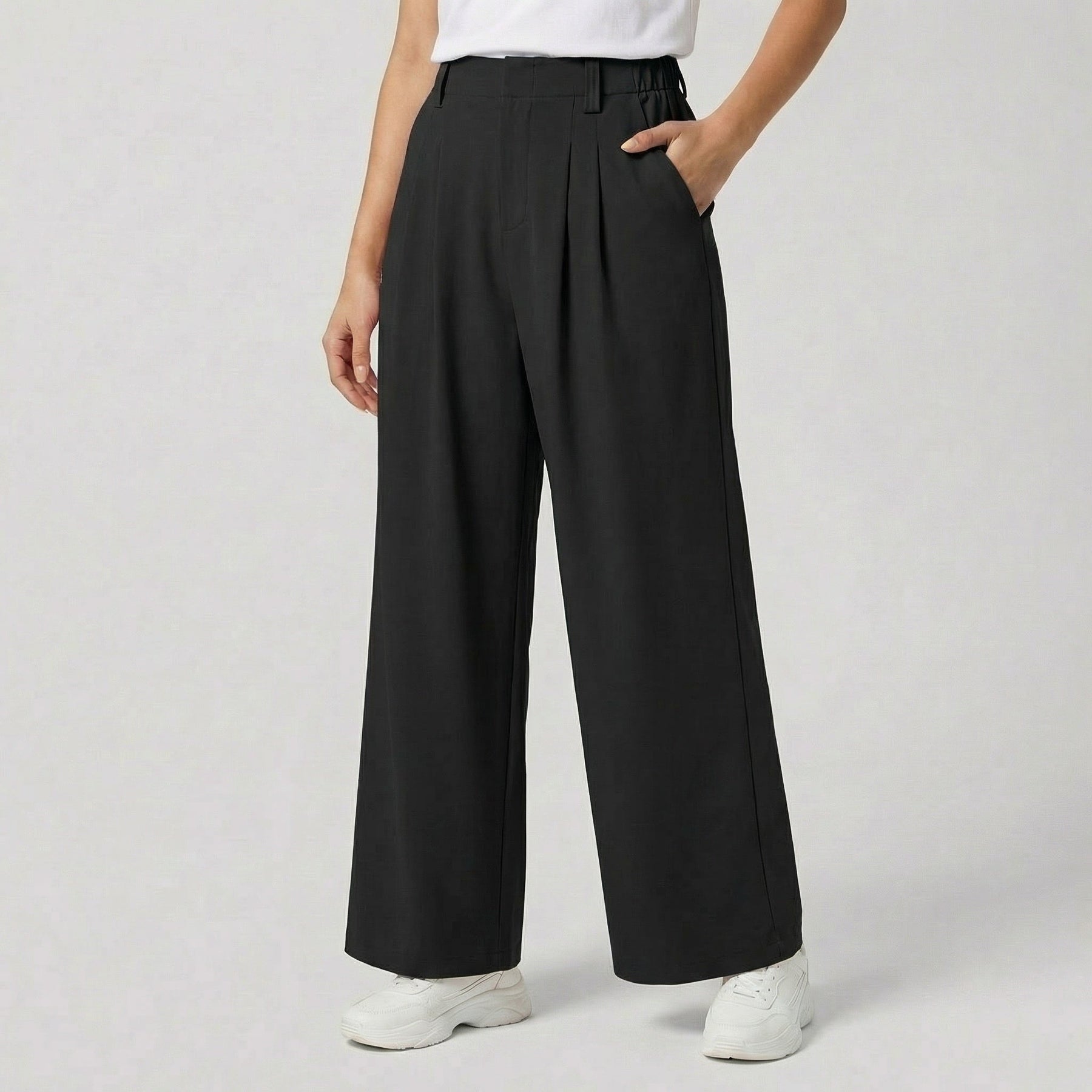Pantaloni donna neri palazzo con pieghe morbide, tasche laterali e orlo ampio