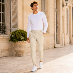 Uomo cammina con pantaloni jogger beige, passanti in vita e fondo a costine