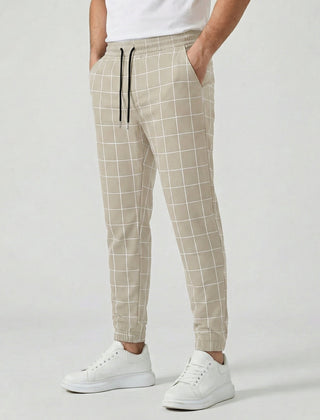 Pantaloni uomo beige a quadri con coulisse nera a contrasto e linea affusolata