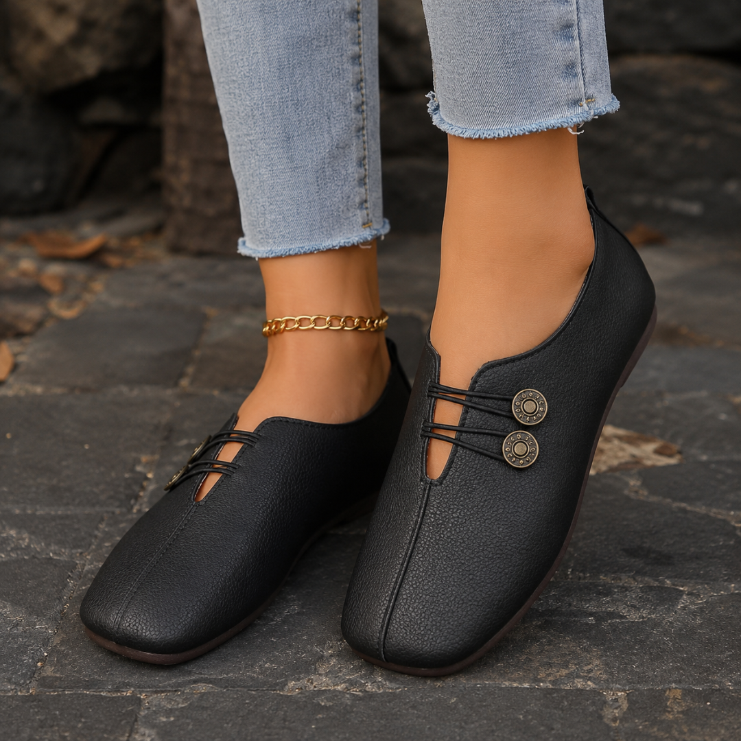 Scarpe basse donna nere con elastici incrociati, bottoni decorativi e punta arrotondata