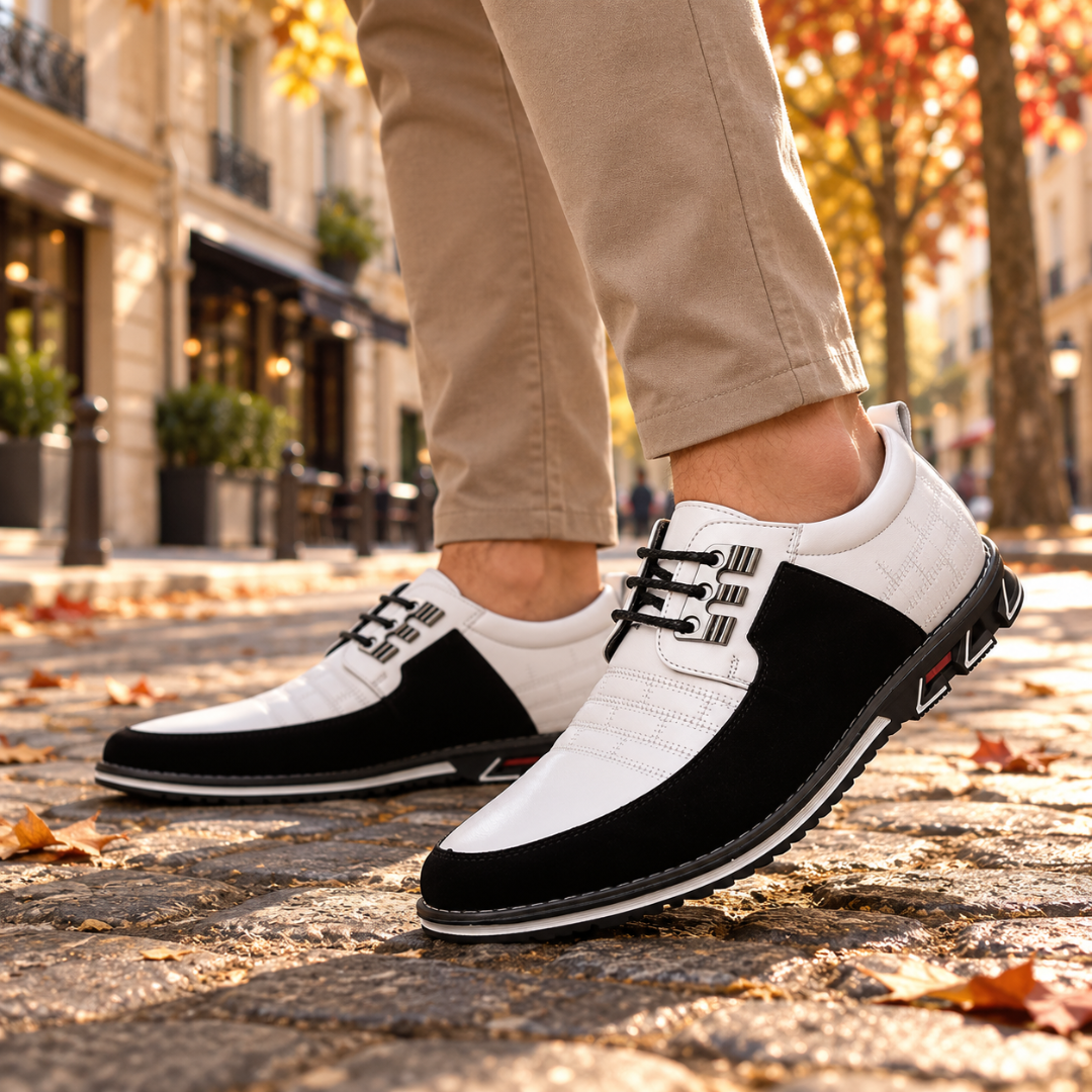 Dettaglio scarpe stringate uomo bianche con lacci neri e ganci metallici