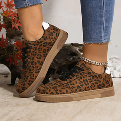 Sneakers leopardate indossate con pantaloni azzurri, inserto bianco visibile sul tallone