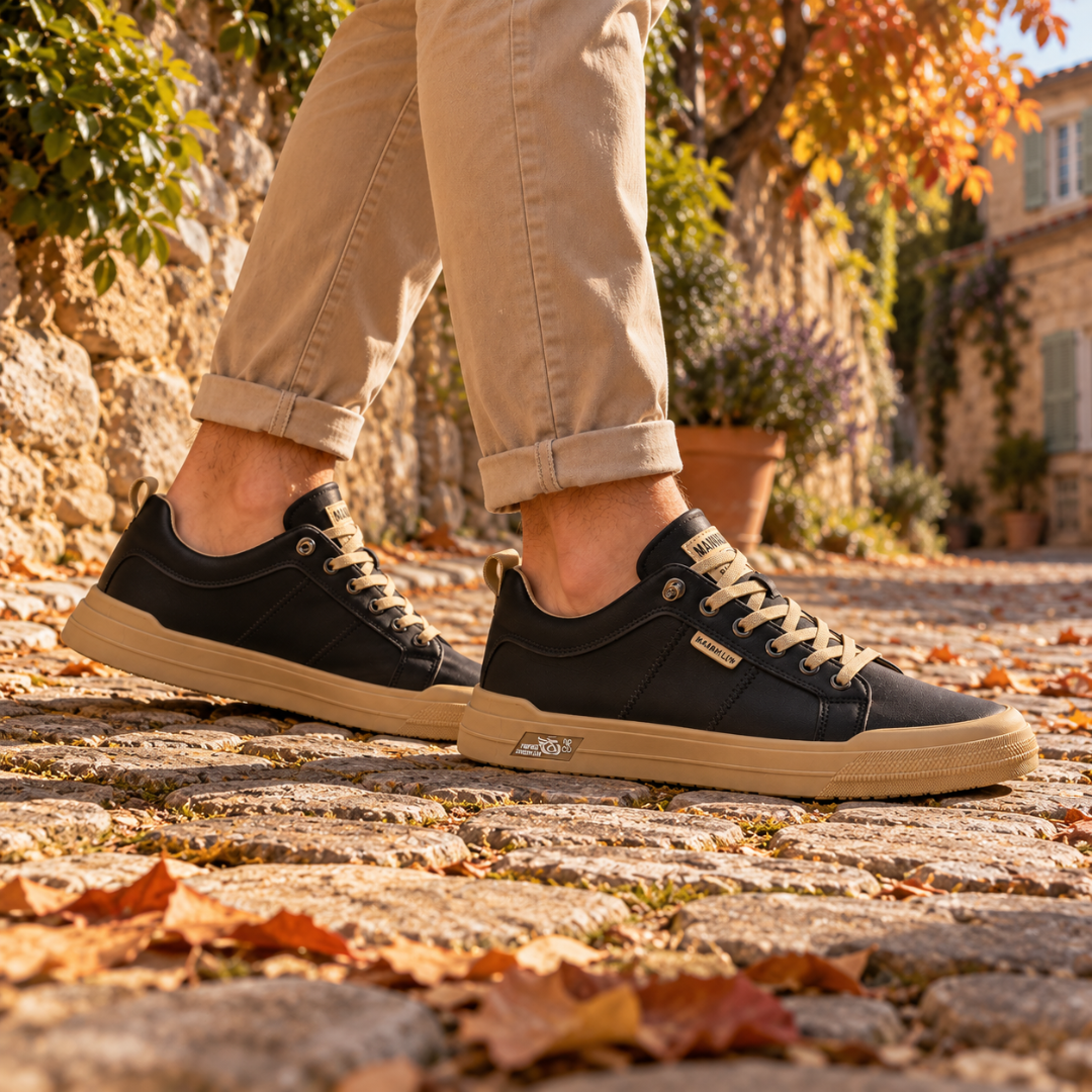 Sneakers uomo nere basse di profilo, suola a contrasto e occhielli metallici