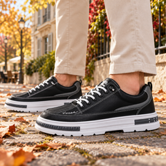 Sneakers uomo nere di profilo con cuciture chiare e inserto grigio laterale