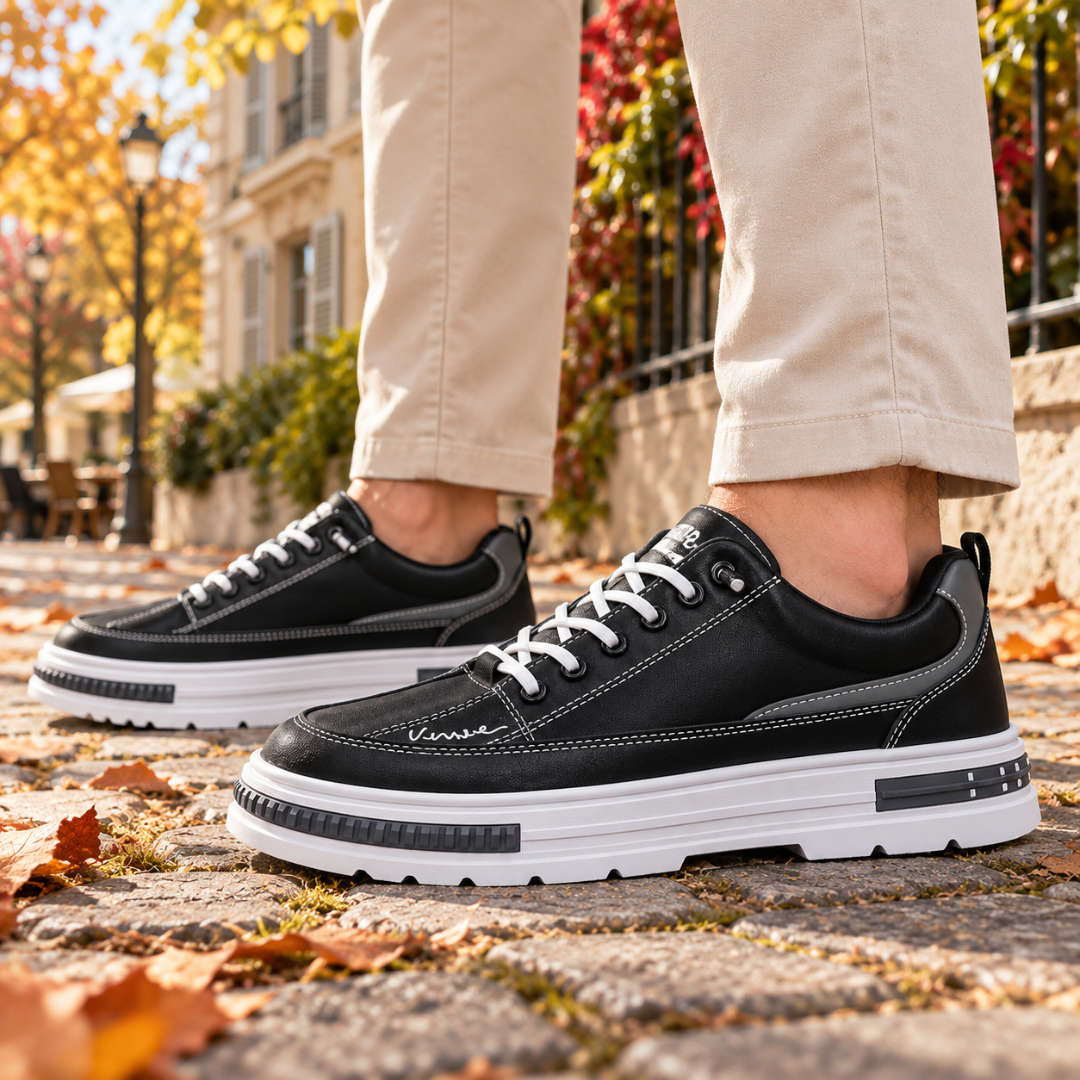 Sneakers uomo nere di profilo con cuciture chiare e inserto grigio laterale