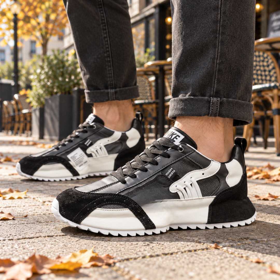 Sneakers uomo nere con inserti bianchi a contrasto e suola dentellata bianca
