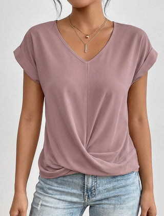 T-shirt donna rosa con scollo a V e nodo frontale, abbinata a pantaloni chiari
