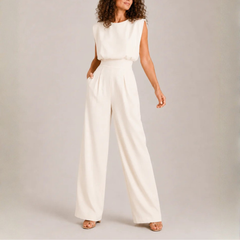 Tuta donna crema senza maniche con pantalone ampio e pieghe frontali