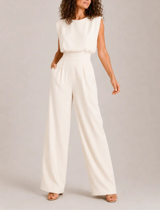 Tuta donna crema senza maniche con pantalone ampio e pieghe frontali