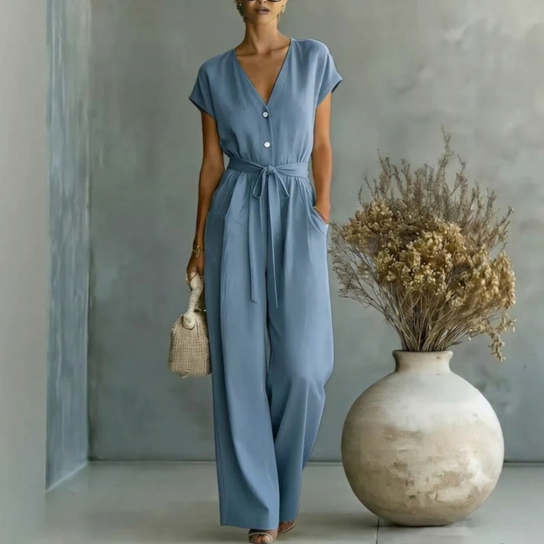 Tuta donna lunga blu con scollo a V, bottoni chiari e pantalone a gamba larga