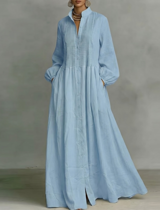 Vestito lungo azzurro con nervature sul corpetto, maniche lunghe e gonna fluida