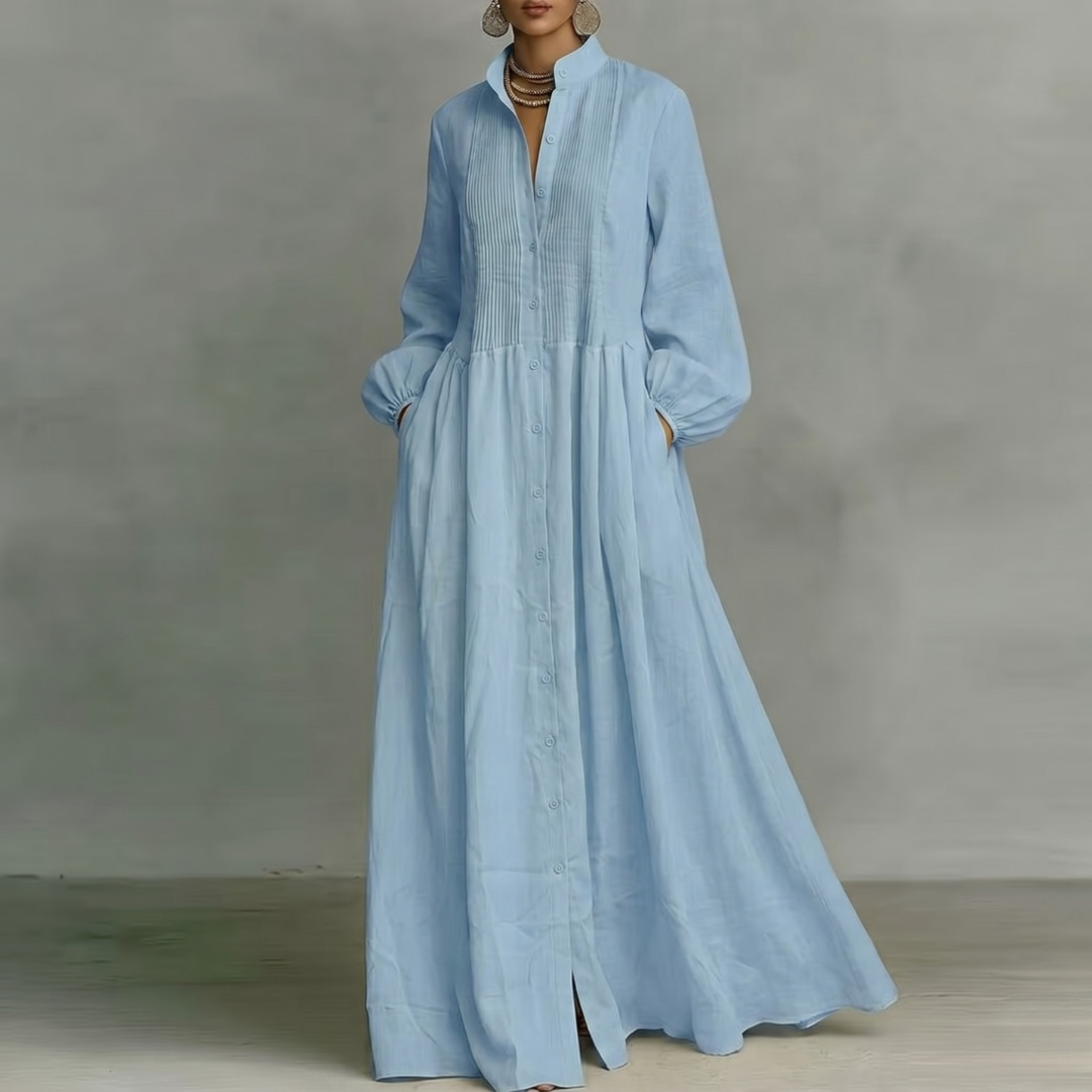 Vestito lungo azzurro con nervature sul corpetto, maniche lunghe e gonna fluida