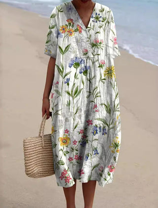 Vestito midi donna bianco con delicati fiori di campo e maniche corte arrotolate