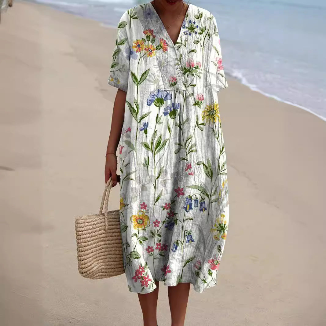 Vestito midi donna bianco con delicati fiori di campo e maniche corte arrotolate
