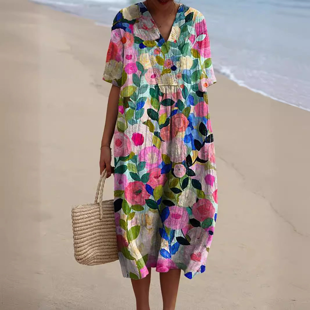 Vestito midi donna rosa con fiori dipinti e scollo a V in spiaggia